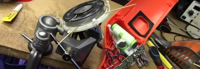 Vacuum cleaner repair parts and tools on a workbench in Boca Raton, FL