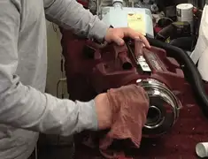 Vacuum repair technician cleaning and servicing a vacuum motor in Boca Raton, FL