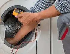Washing machine repair technician testing a front-load washer with diagnostic tools in Boca Raton, FL