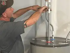 Water heater repair technician tightening supply line connections in Boca Raton, FL